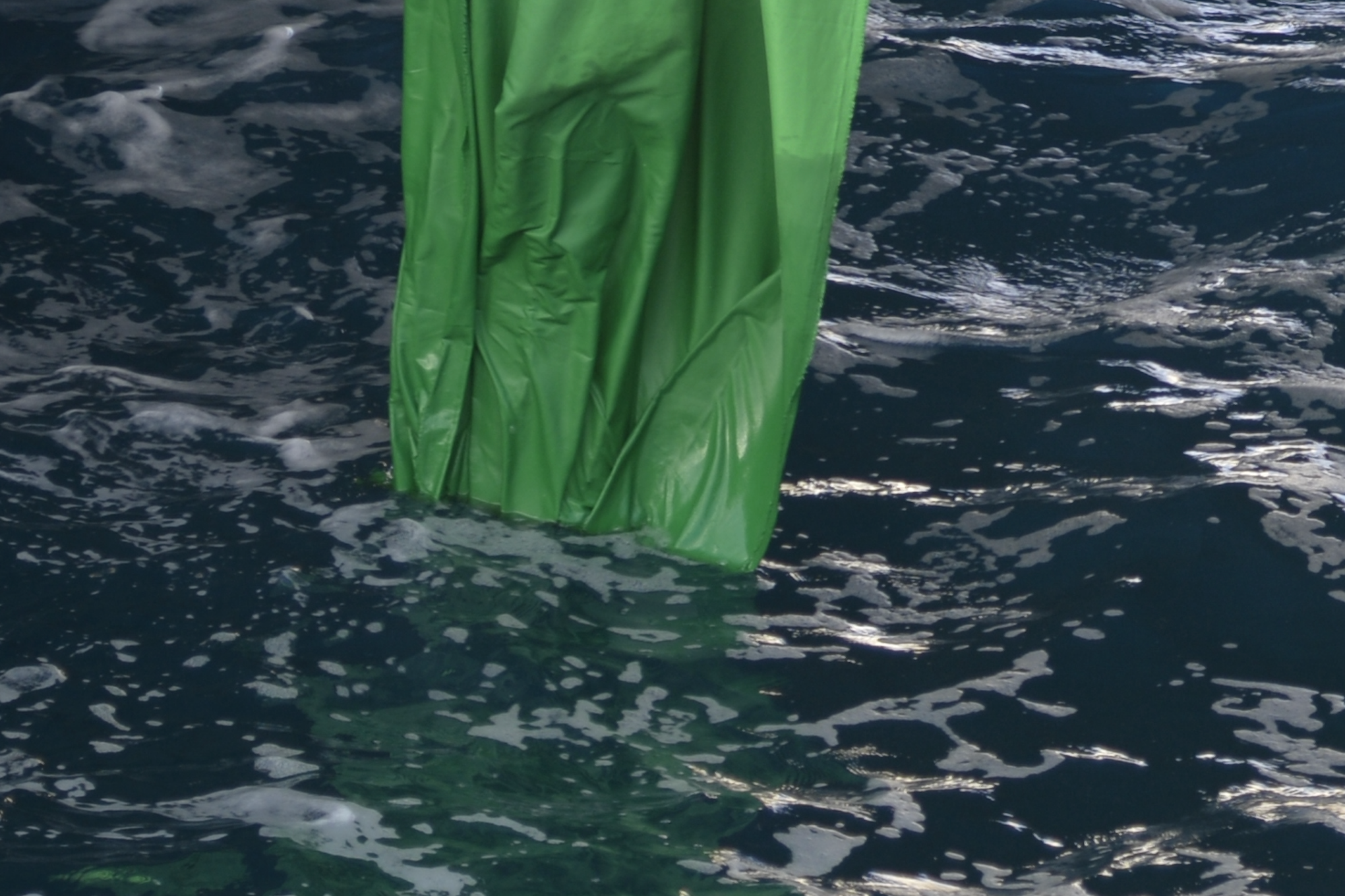 Green-screen fabric meeting the seawater